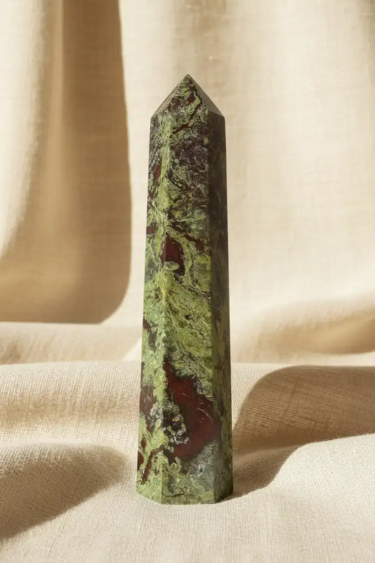 Polished Dragon’s Bloodstone Tower showing beautiful deep forest green epidote and red piemontite, background brown burlap fabric