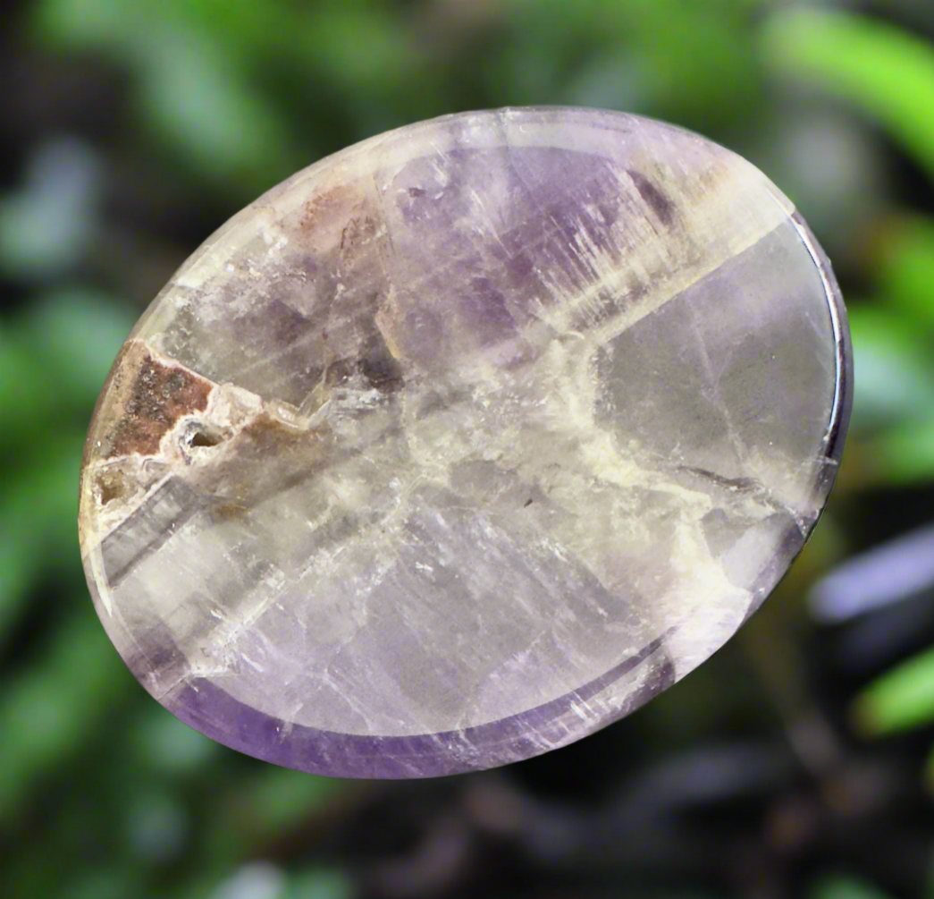 Oval-shaped amethyst cabochon.
