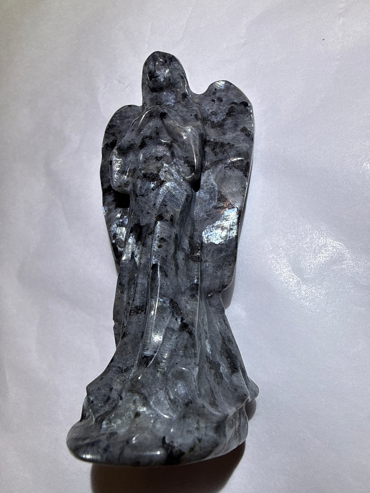 photo of larvikite hand carved angel with obvious silvery blue shimmering flash