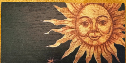 Wooden plaque with a sun face design.