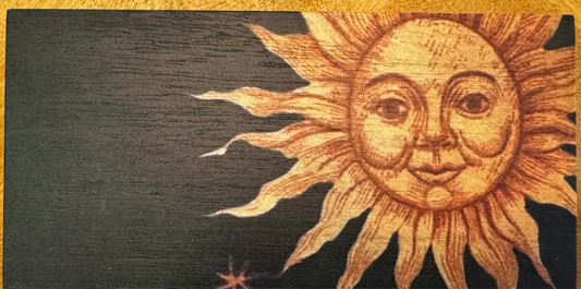 Wooden plaque with a sun face design.
