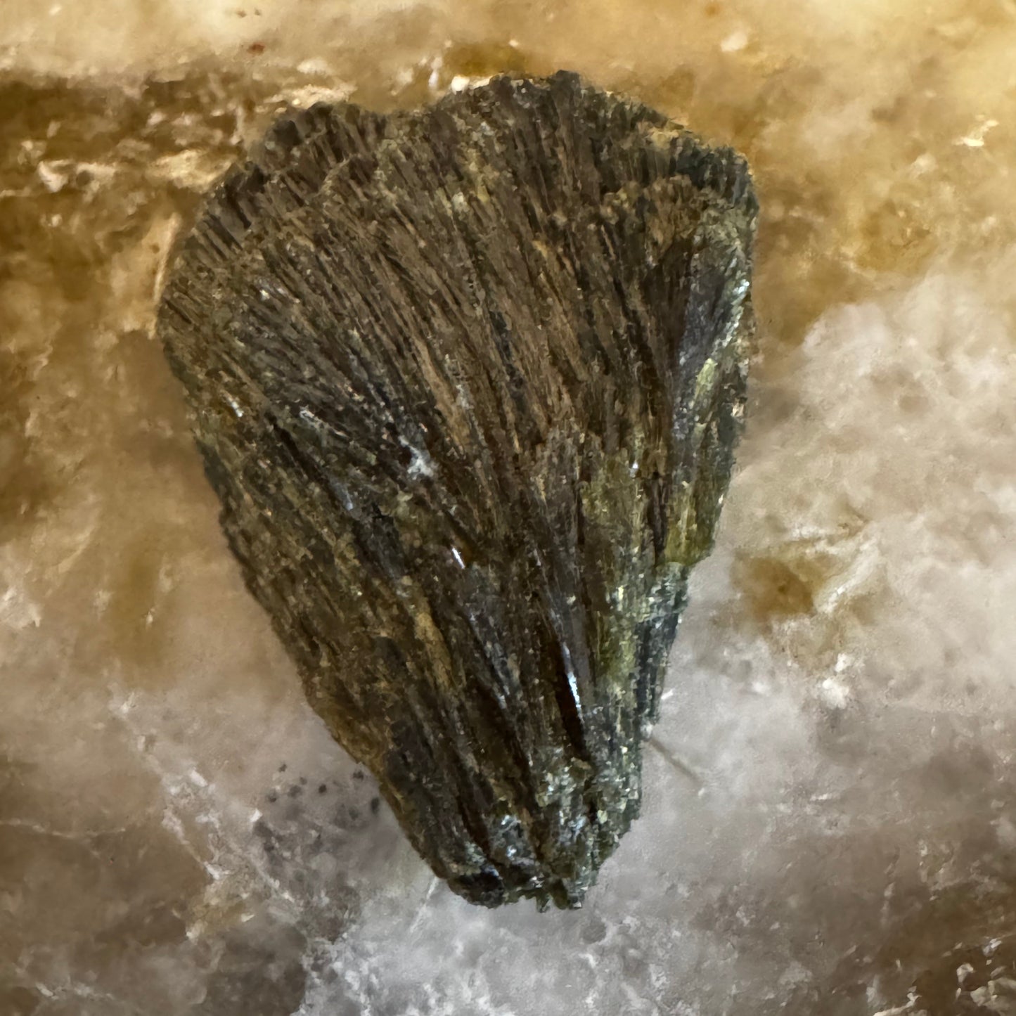 Raw specimen of epidote on a slab