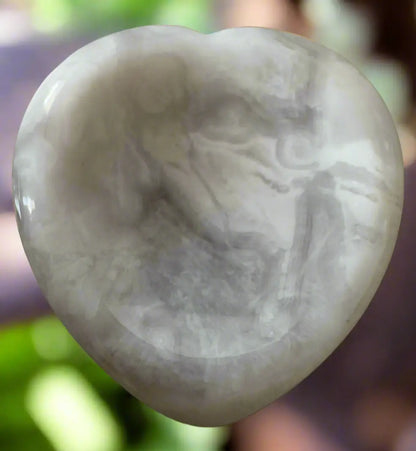 Polished white and gray heart-shaped stone.
