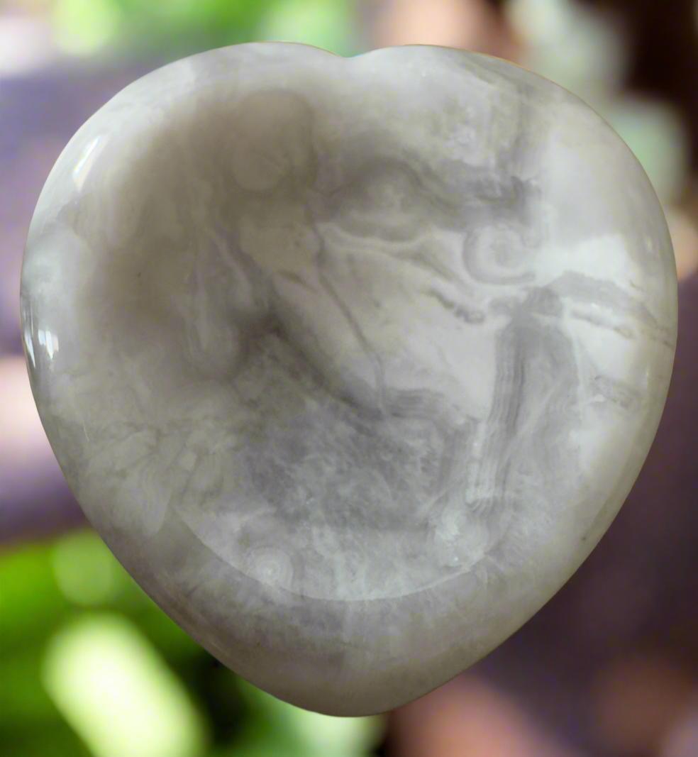 Polished white and gray heart-shaped stone.
