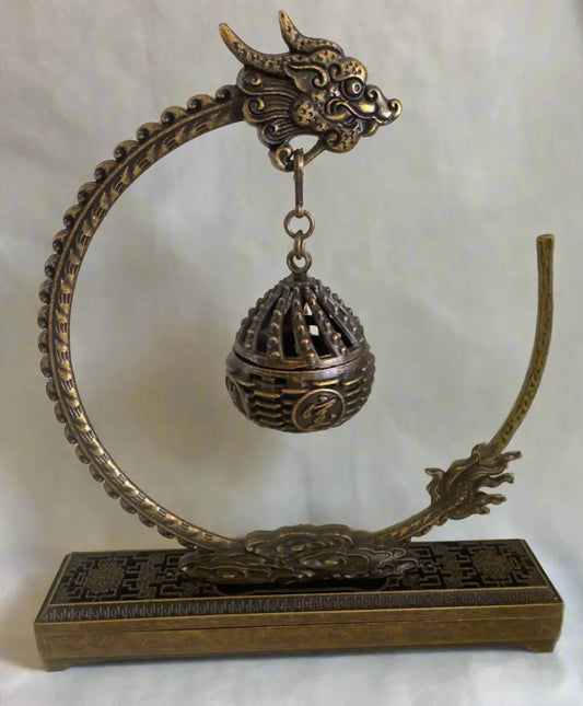 Brass dragon incense holder with spherical lattice burner front view