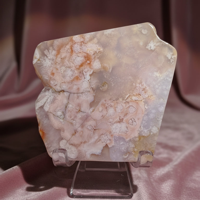 A polished flower agate, pink and white  stone with coral-like patterns.