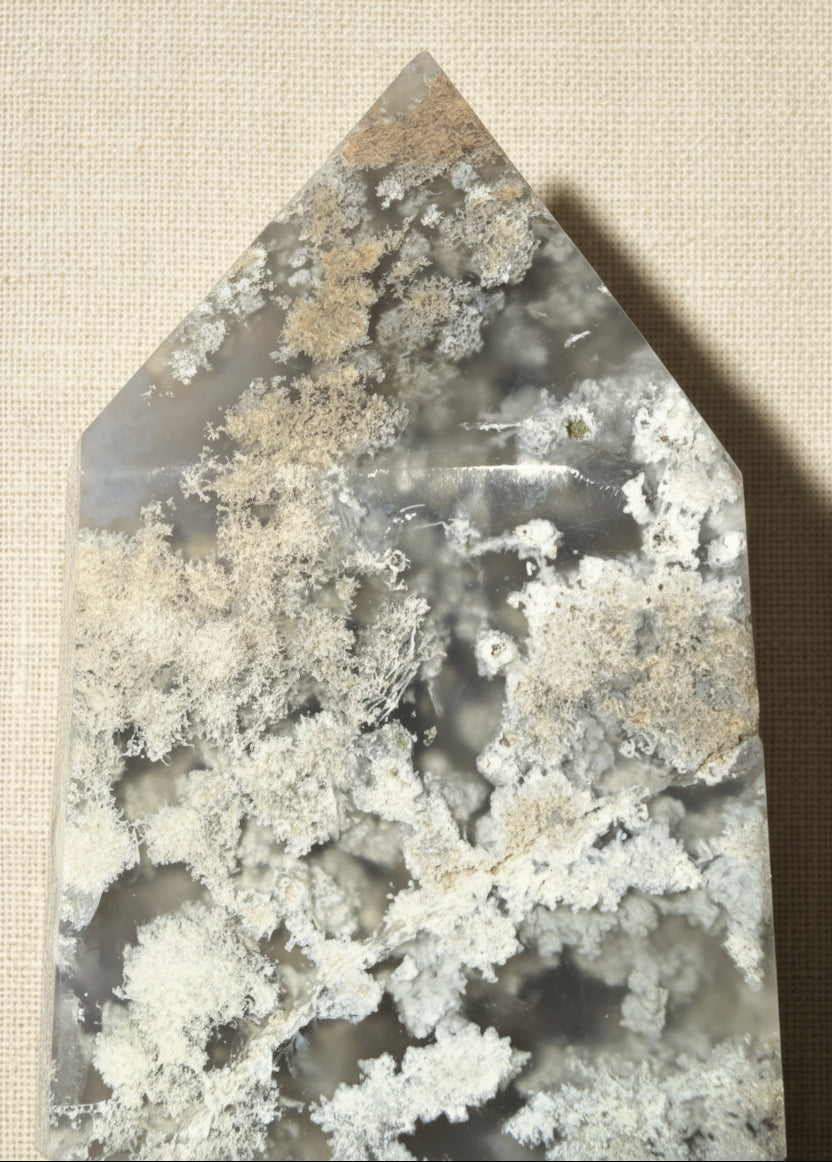 close up of flower agate carved tower showing tip and possible manganese inclusions