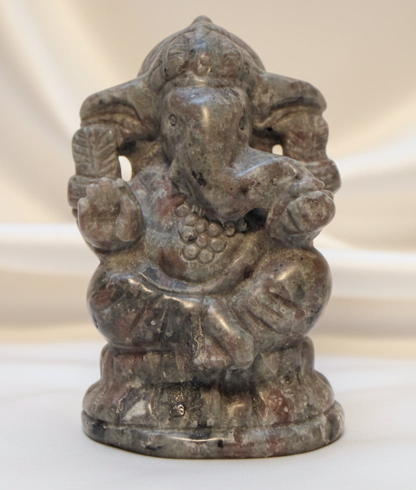 A small carved Ganesha statue  carved from Yooperlite.  uv reactive very intricate hand carving
