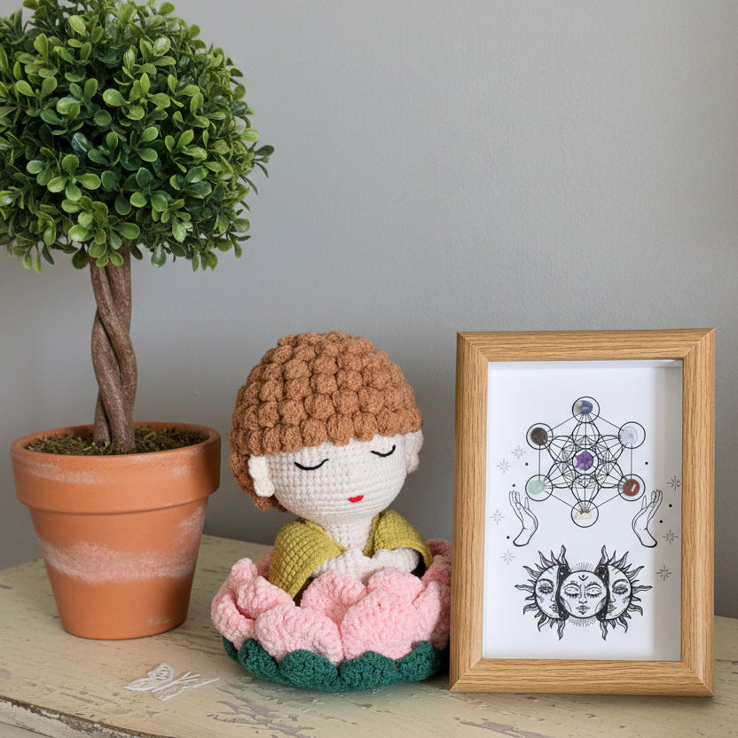 Crocheted buddha doll on a lotus flower with a chakra grid shadow box. Genuine Chakra crystals included in the grid 