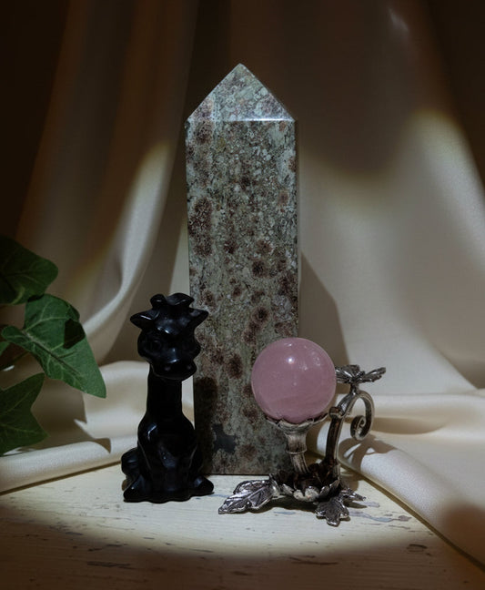 Large rainforest tower, beautiful hand carved giraffe black obsidian great detail, silvery sphere with butterfly and rose quartz sphere