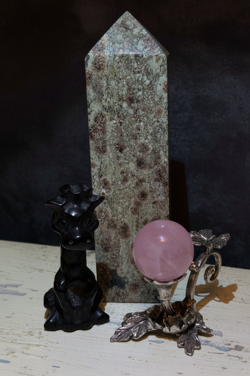 photograph rainforest jasper tower, hand carved black obsidian giraffe, silvery sphere stand with butterfly adornment and rose quartz sphere