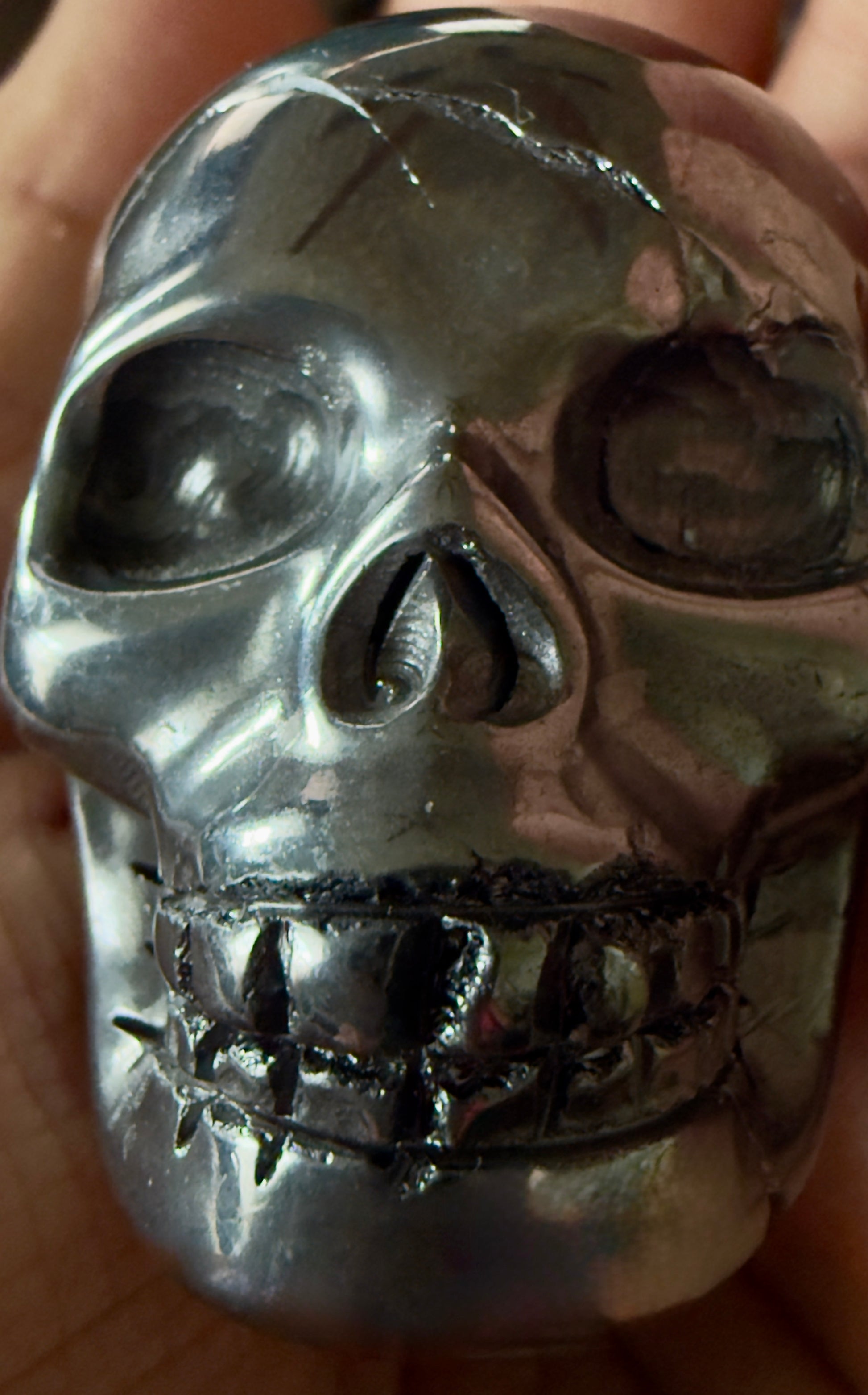 close of of genuine hematite mineral showing a skilled shaping of a human skull 