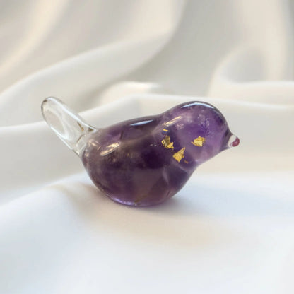 close up of amethyst orgonite bird showing purple amethyst crystals and metal shavings encased in resin Orgon 