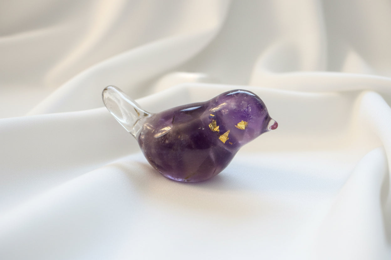 close up of amethyst orgonite bird showing purple amethyst crystals and metal shavings encased in resin Orgon 