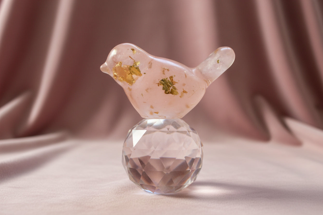 close up of rose quartz orgonite bird with rose quartz crystals and metal shavings encased in resin 