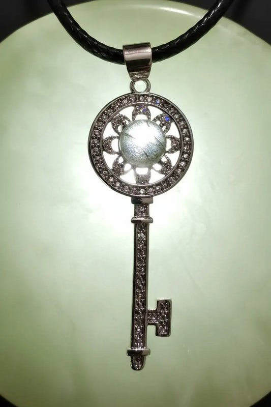silver key with labradorite stone bright light behind to show detail 