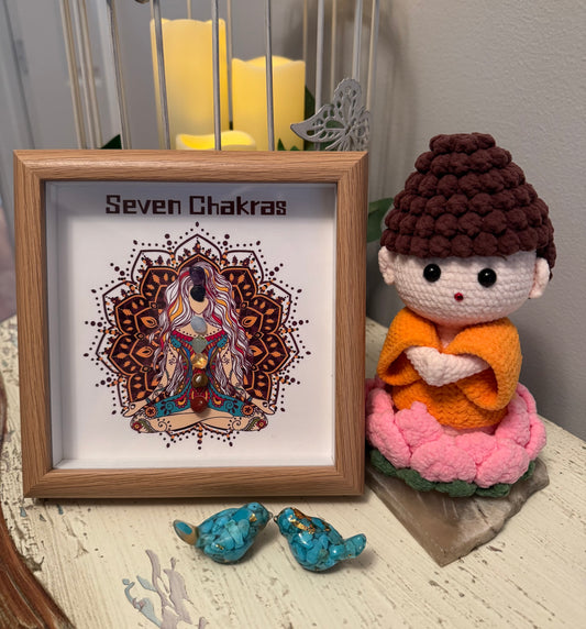 Framed "Seven Chakras" art, crocheted figure in lotus position, turquoise birds, birdcage with candles.