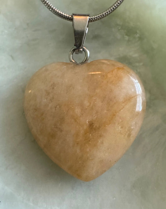 Natural Citrine heart pendant with stainless steel chain close-up
