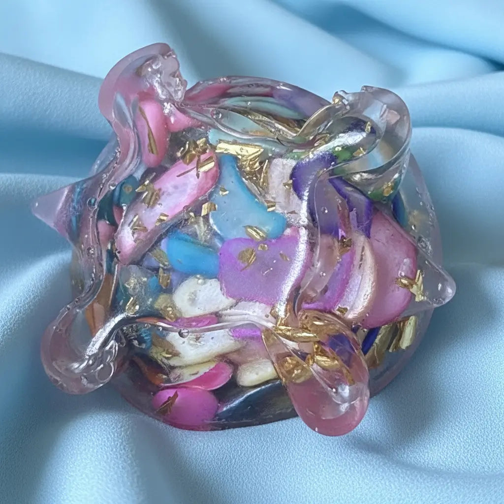 close up of mini resin carnival colors dyed agate filled. close up of belly showing metal shavings and dyed agate chips