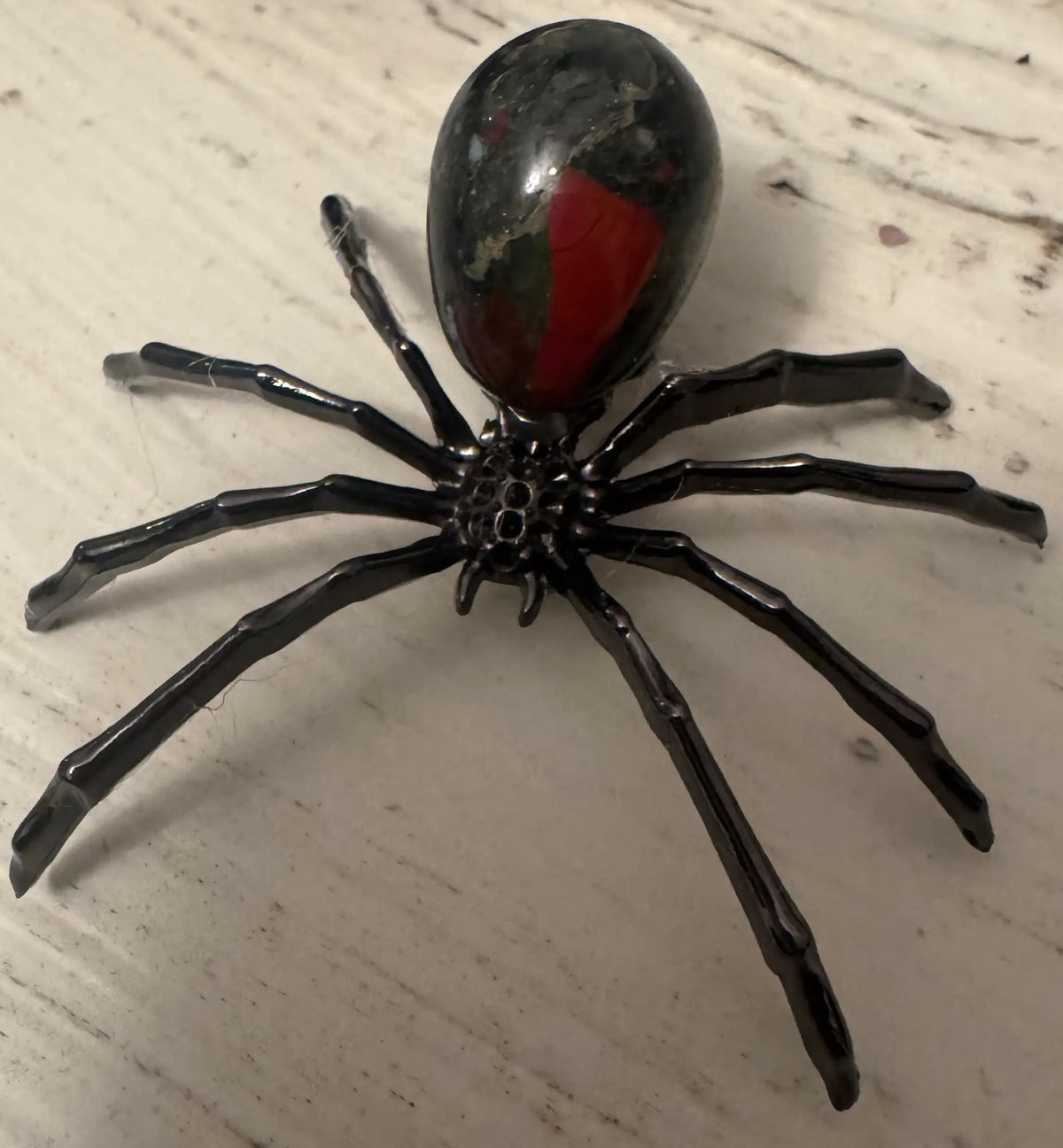 Black metal legs spider with dragons blood crystal stone body 