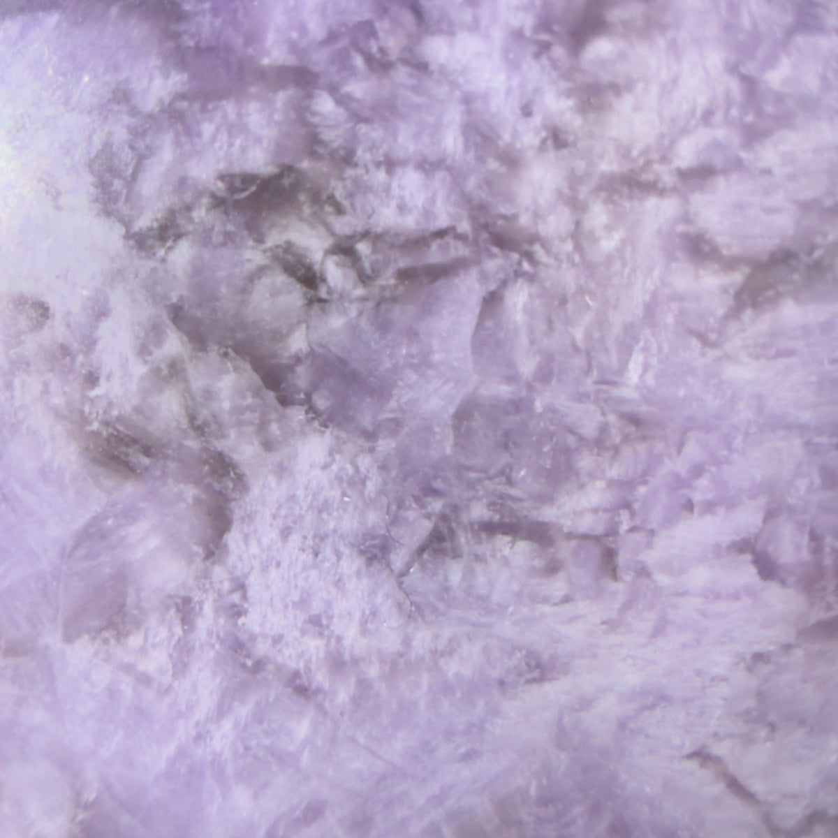 close up amethyst sphere showing zig zag in purples and whites 