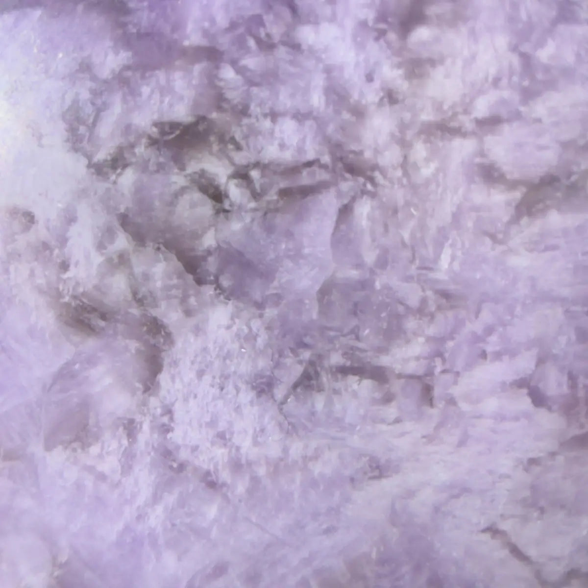close up amethyst sphere showing zig zag in purples and whites 