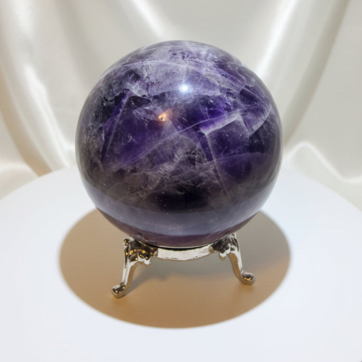 natural amethyst sphere beautiful fractures light and dark purple colors, and iron inclusions - possibly hematite
