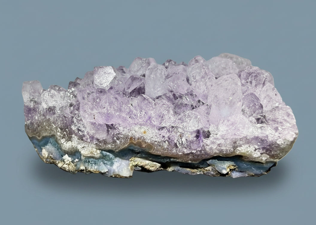 Amethyst crystal cluster on a white background