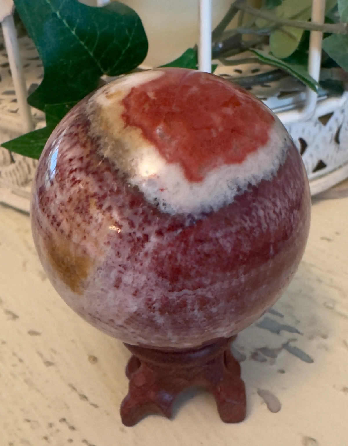Rhodochrosite sphere self-love crystal front view