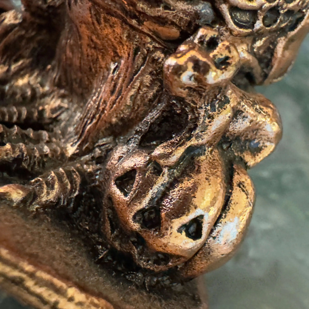 Bronze Owl Crown stand detail with sculpted accents