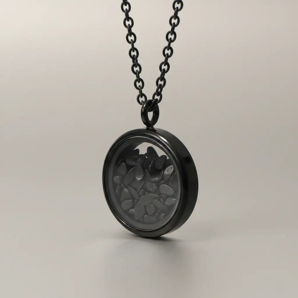 Glass keepsake locket necklace with small black stones