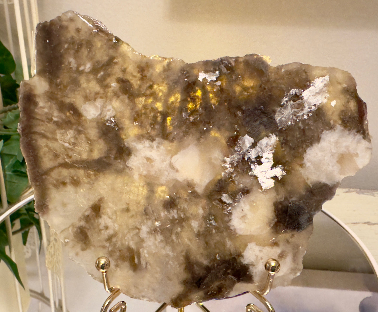 A stone display on a gold stand.
