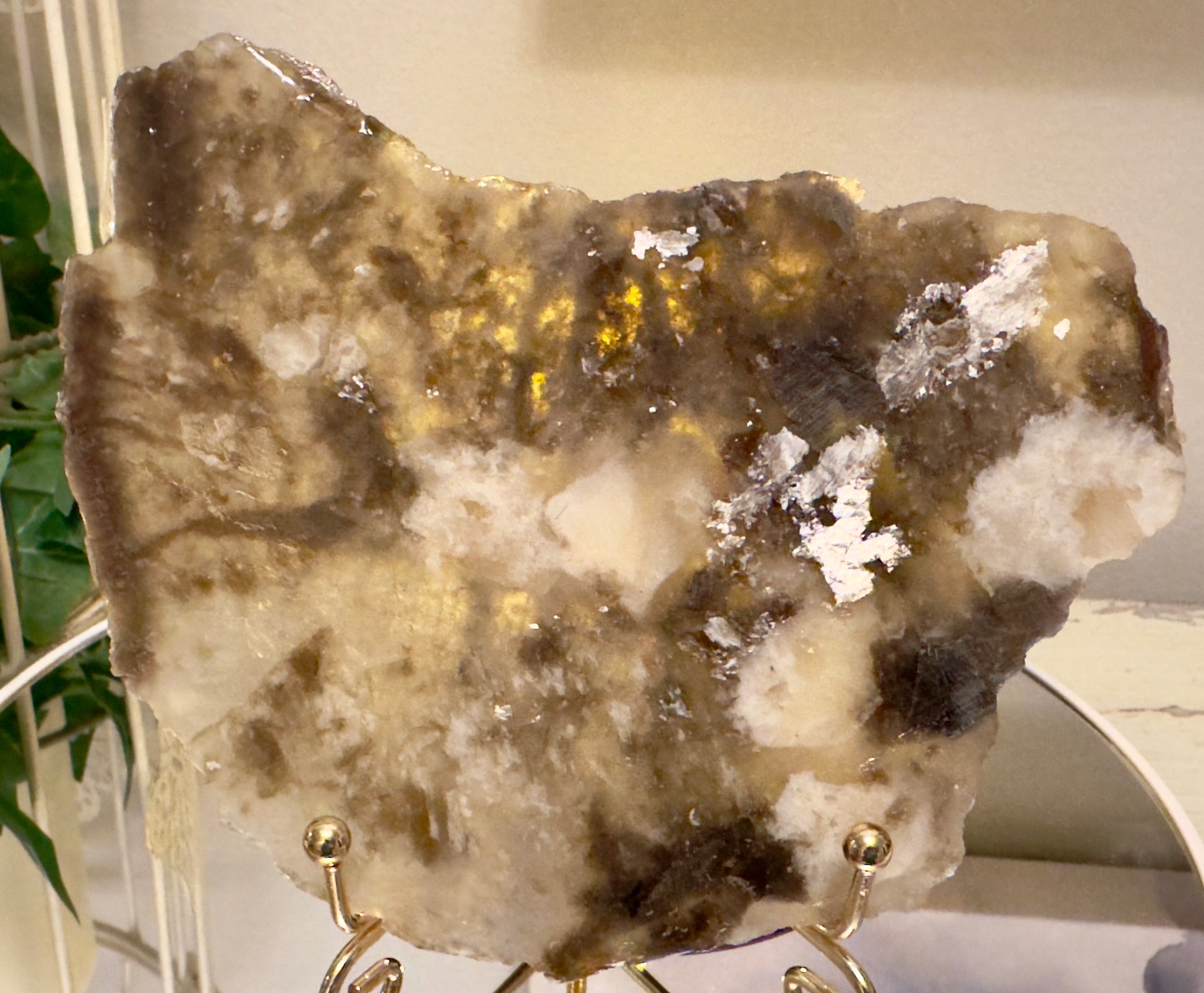 A stone display on a gold stand.