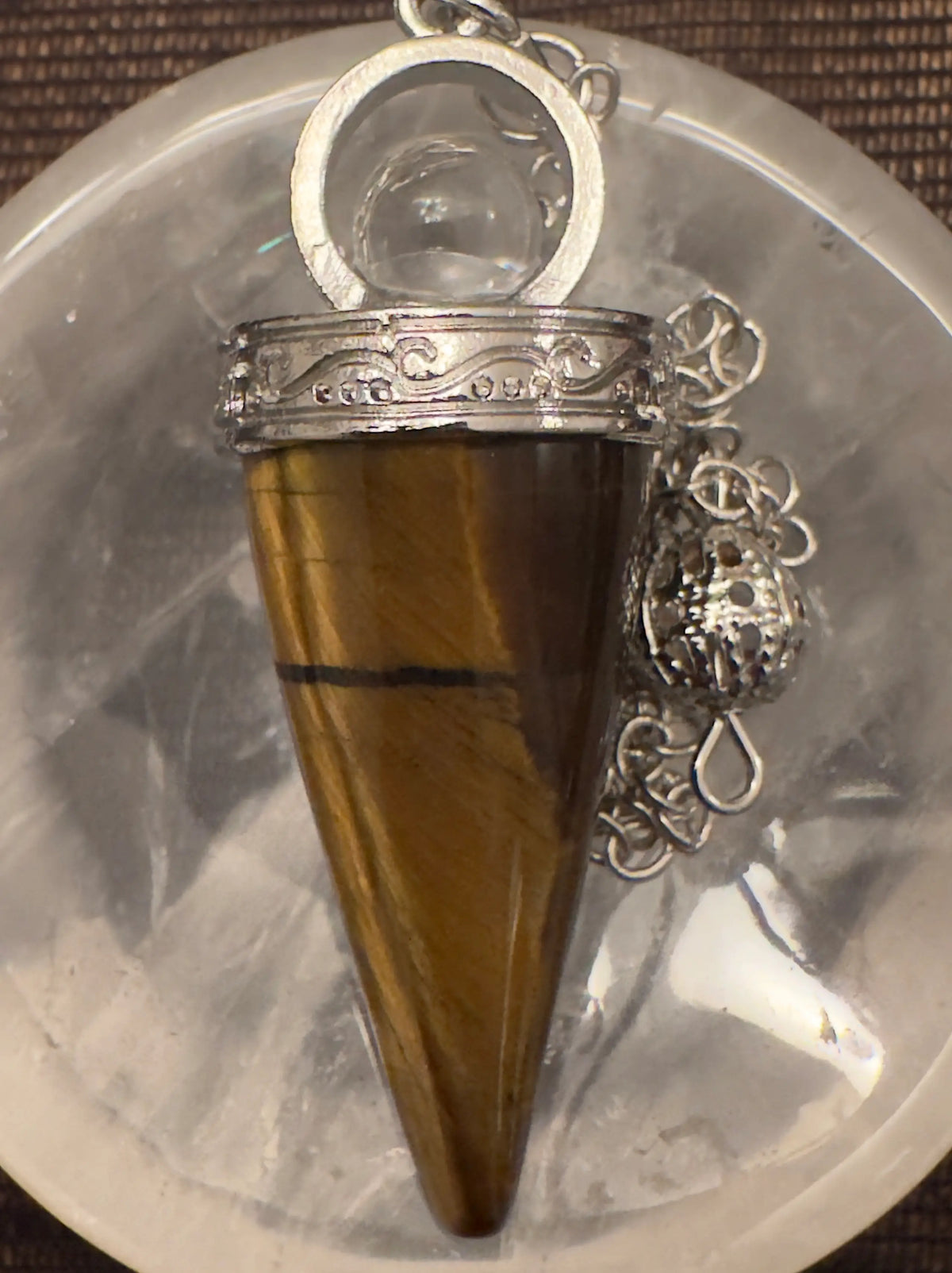 Tiger's eye pendulum with silver filigree.