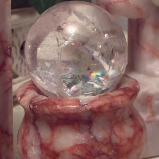 Crystal ball in a marble bowl.