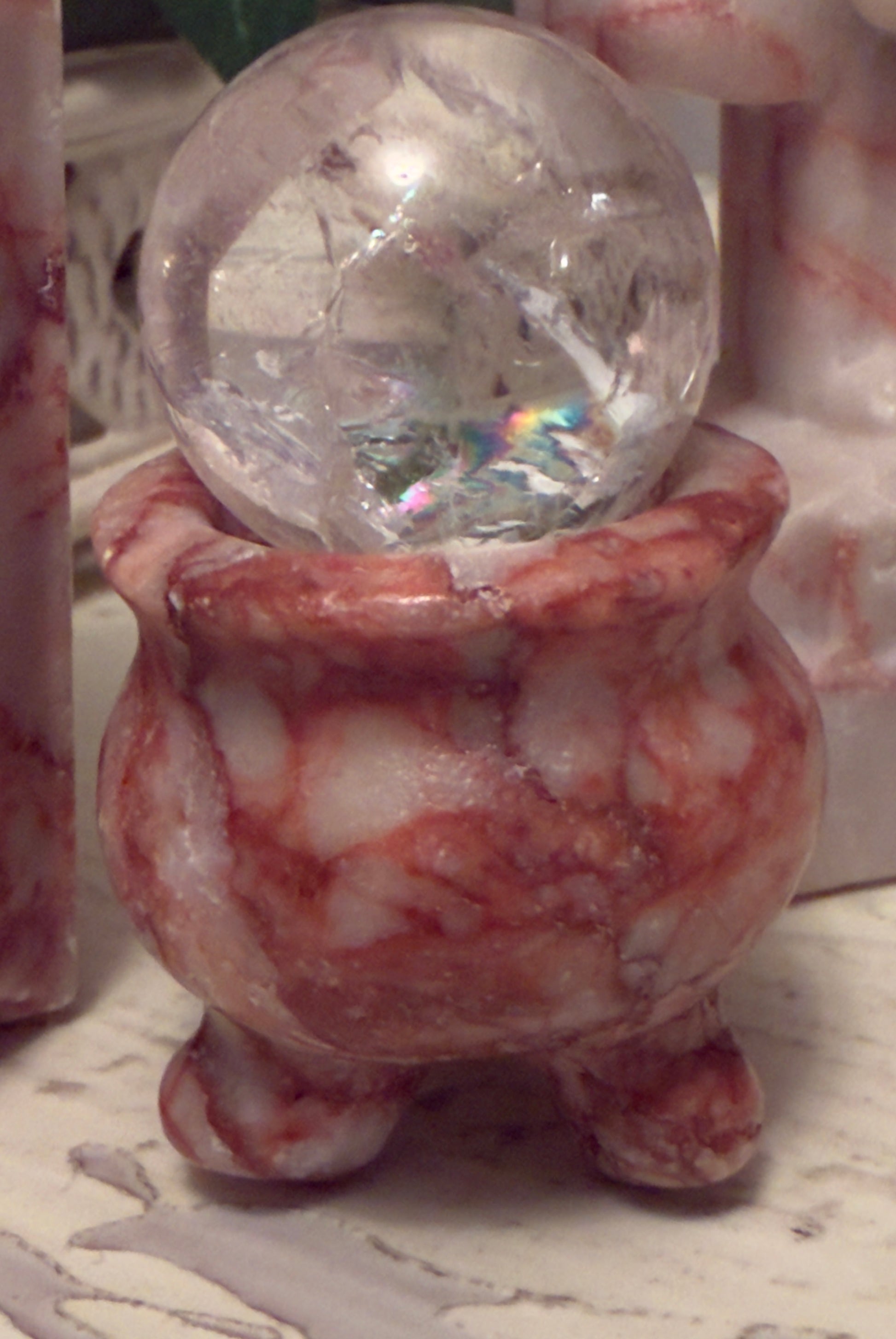 Crystal ball in a marble bowl.