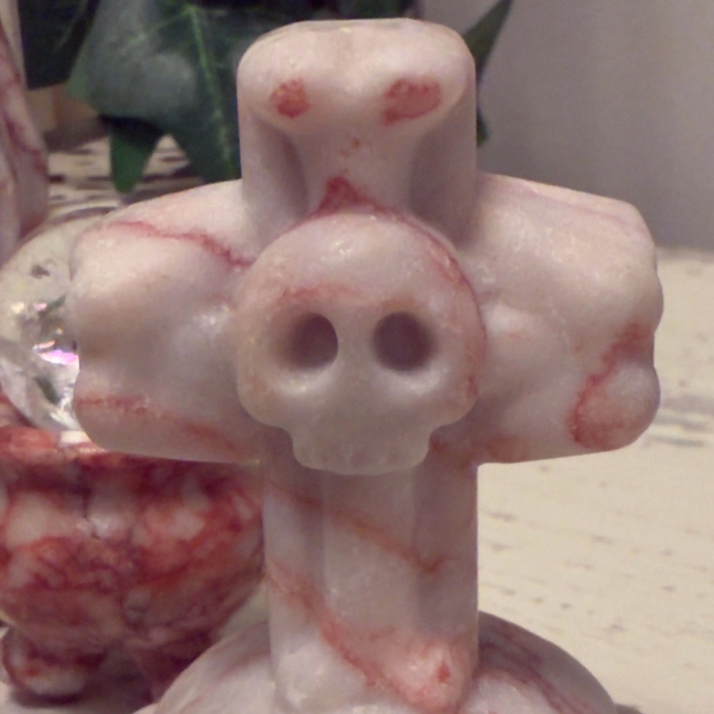 Marble sculpture of cross with skull.