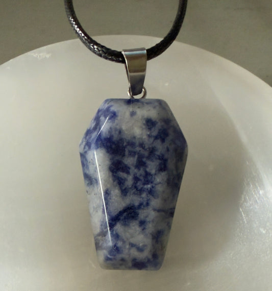 Blue and white coffin-shaped gemstone pendant on a black cord.