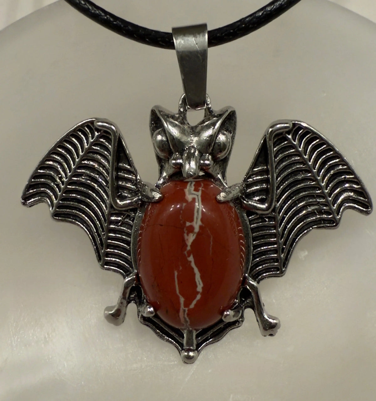 Natural crystal point bat pendant close-up