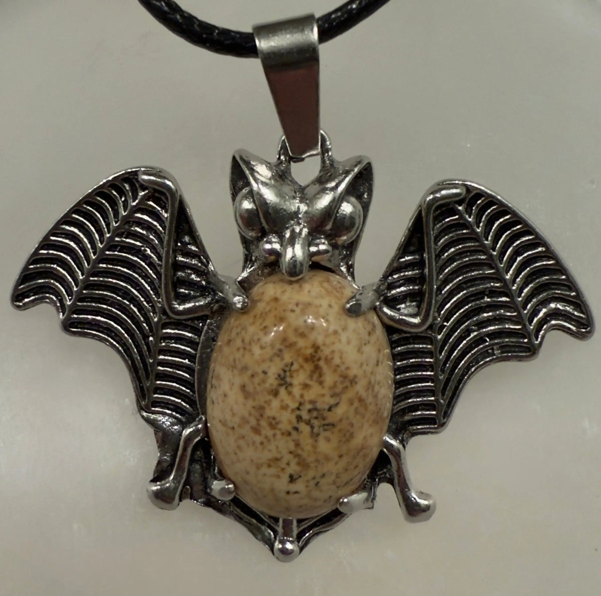 Bat pendant with crystal point on display
