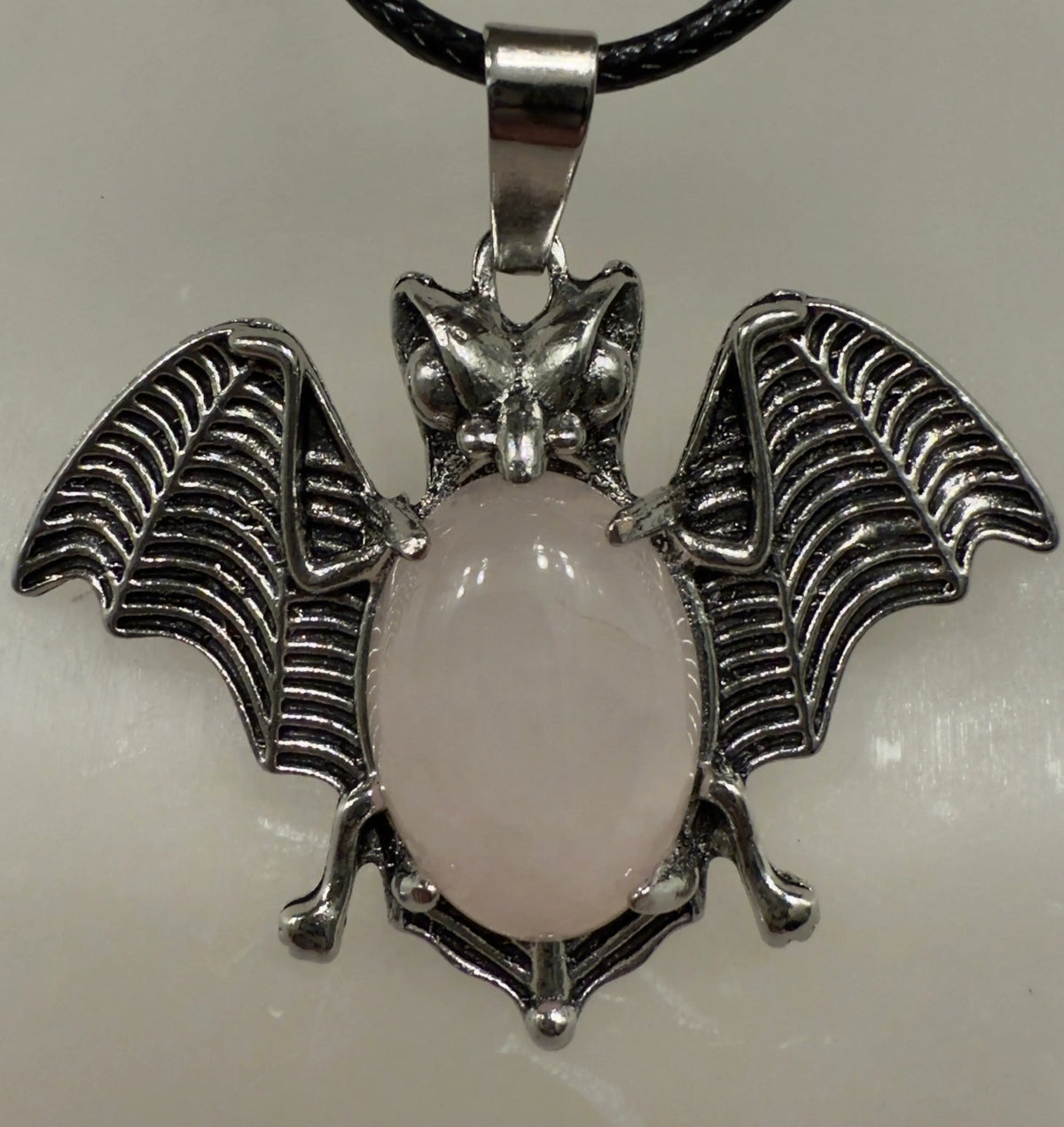 Bat pendant with natural crystal point angled view