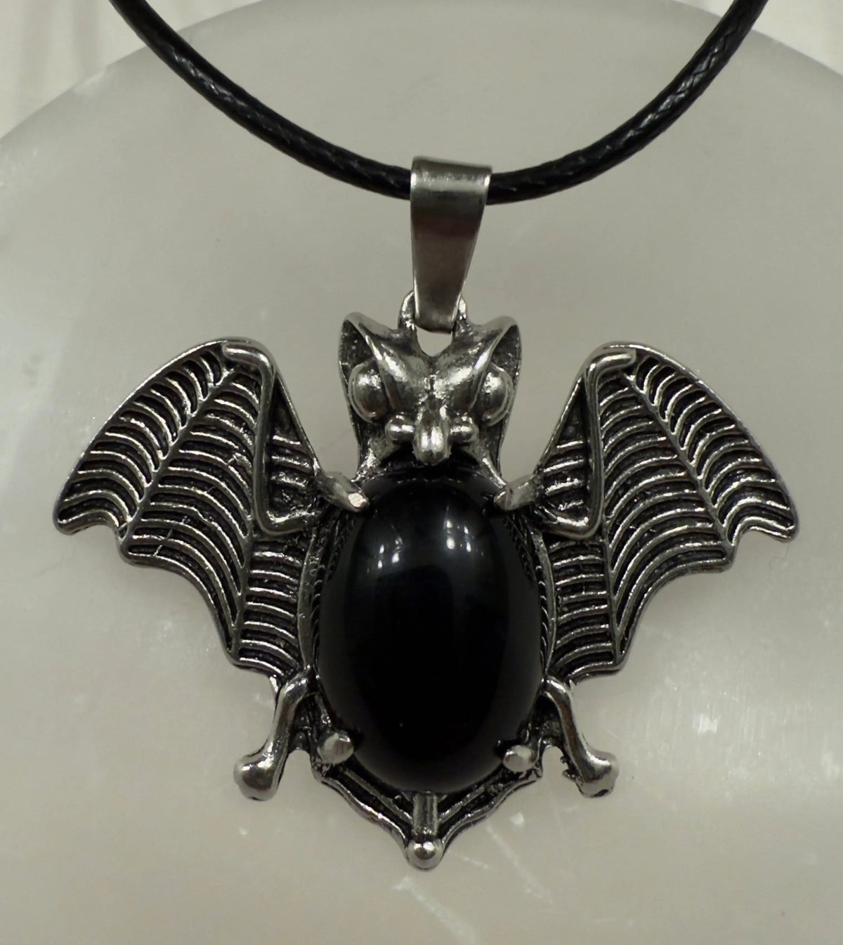 Bat pendant with natural crystal point front view