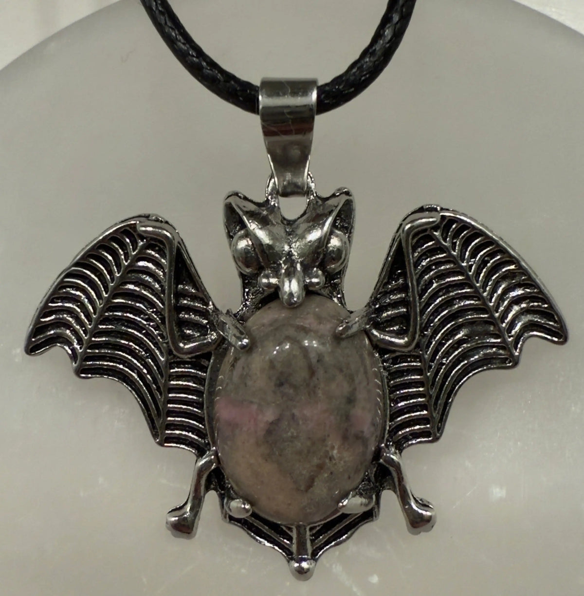 Bat pendant with natural crystal point side view