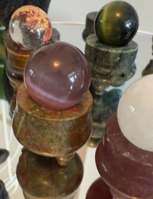 Assorted crystal spheres on mini cauldron sphere holders