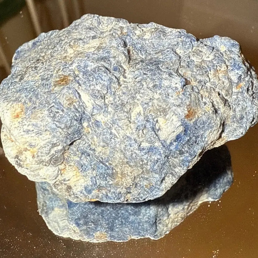 Large sodalite raw specimen on a mirror table
