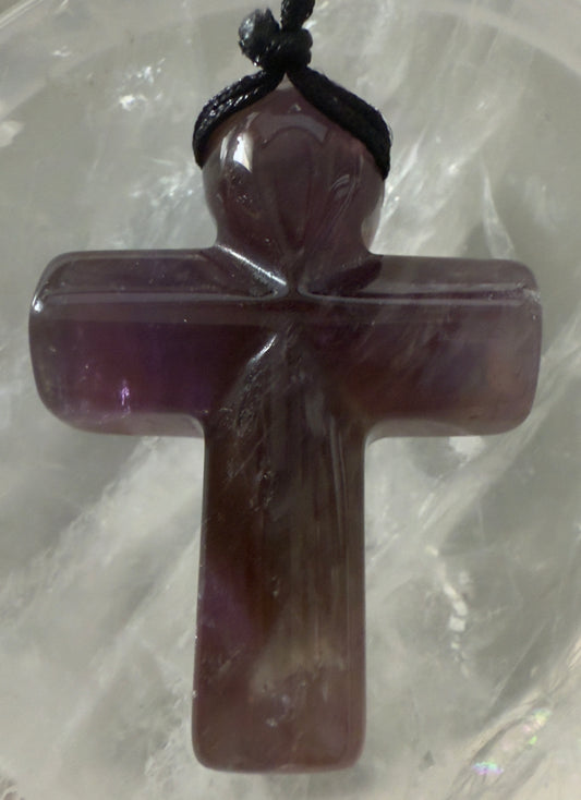 Amethyst cross pendant with black cord.
