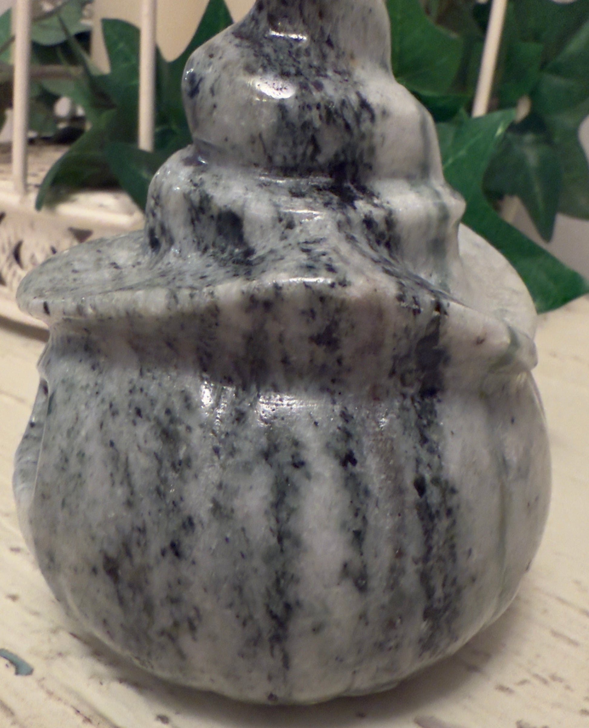 Marble decorative object with stacked, rounded tiers.
