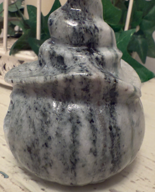 Marble decorative object with stacked, rounded tiers.
