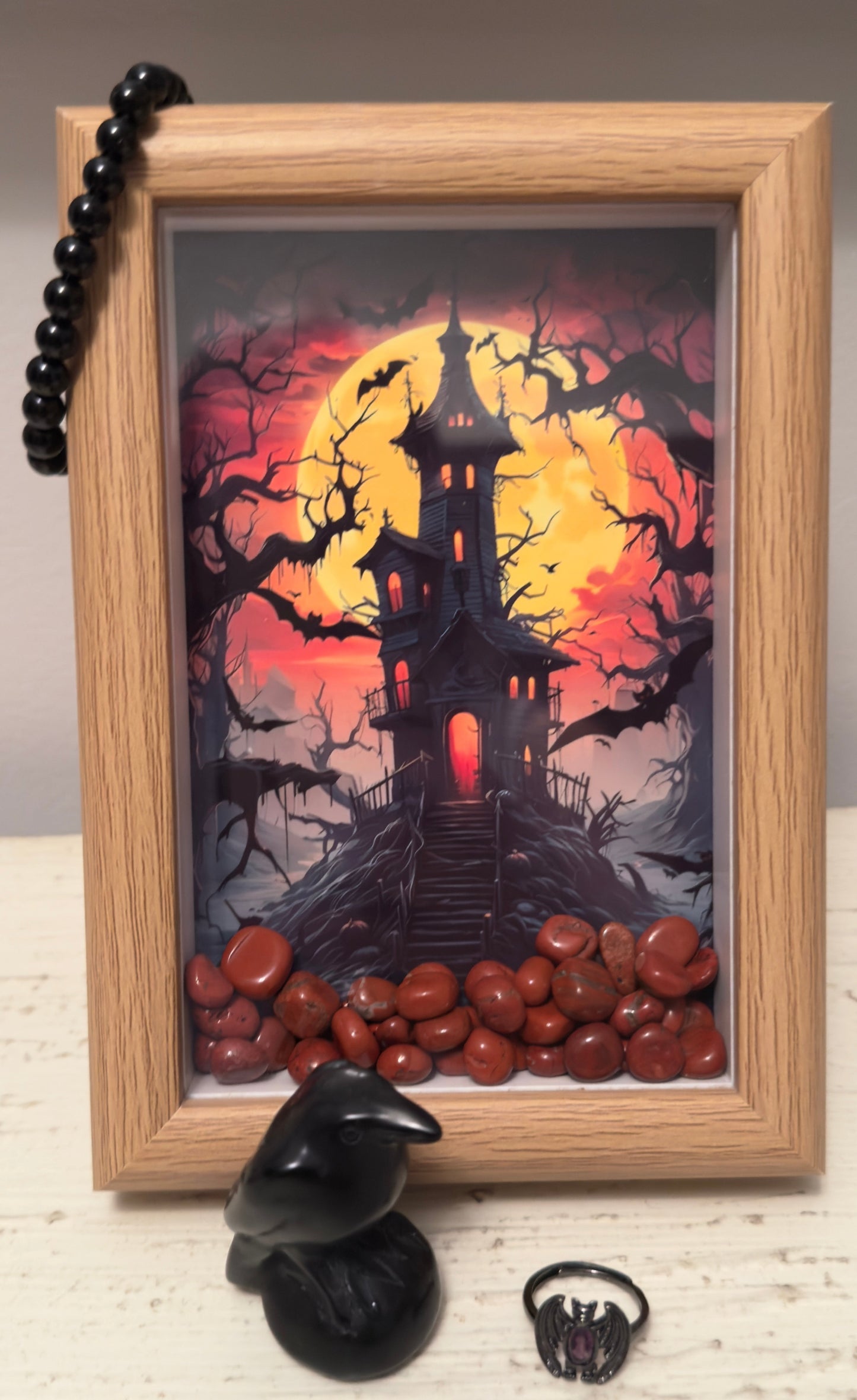 Framed Haunted House Art Work with Red Jasper Crystal inside the Frame. Crystal Set Black Obsidian Carved Raven Bat Ring with crystal center and Black Obsidian 8mm Bead Brac
let