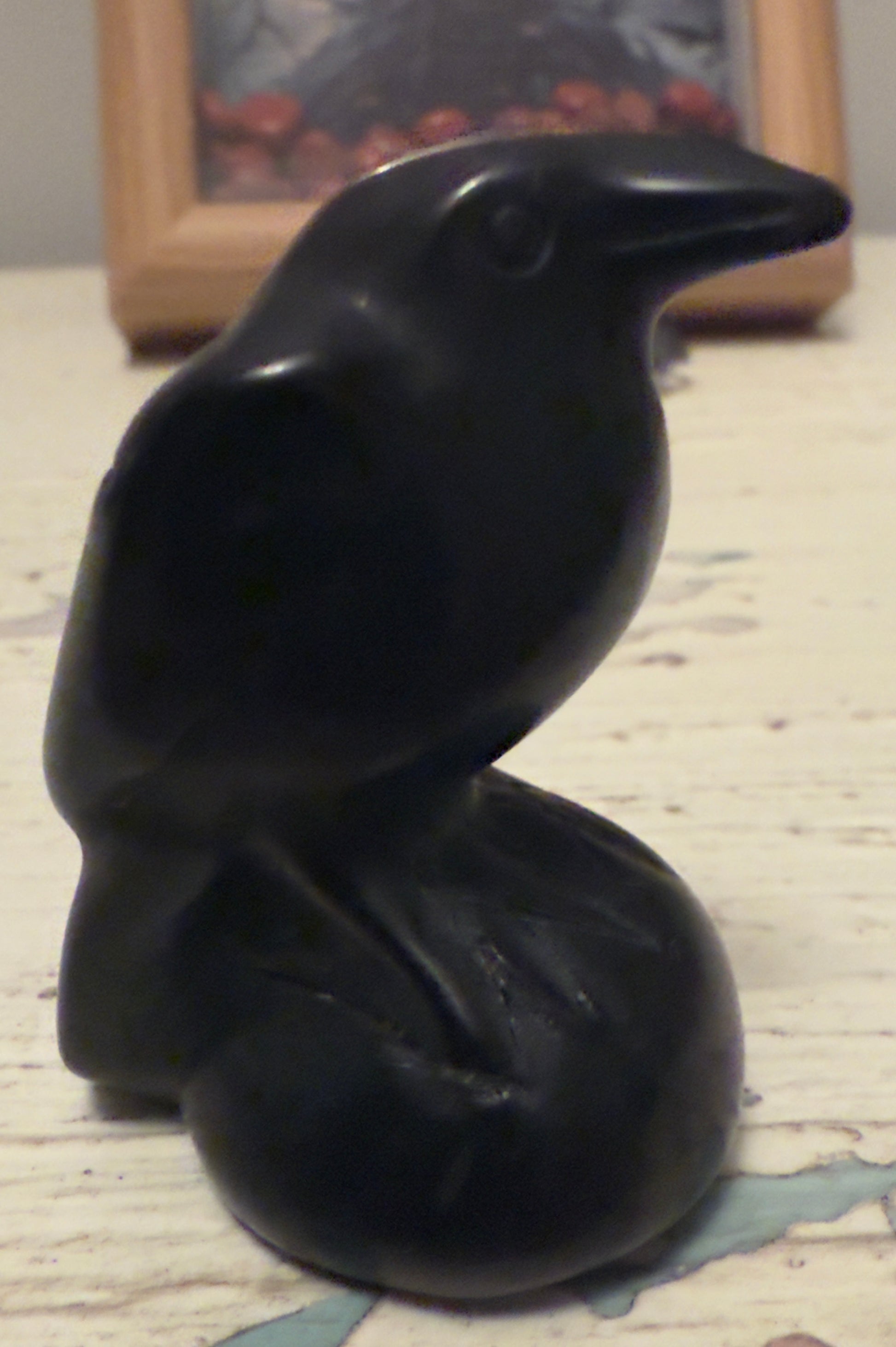 Black bird figurine with smooth, polished surface.